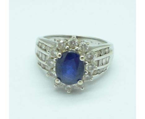 An 18ct gold, sapphire and diamond ring, 7g, N/O, set with thirty-two diamonds, sapphire 8mm x 6mm