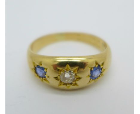 An 18ct gold, sapphire and diamond gypsy set three stone ring, 4g, L, hallmark worn