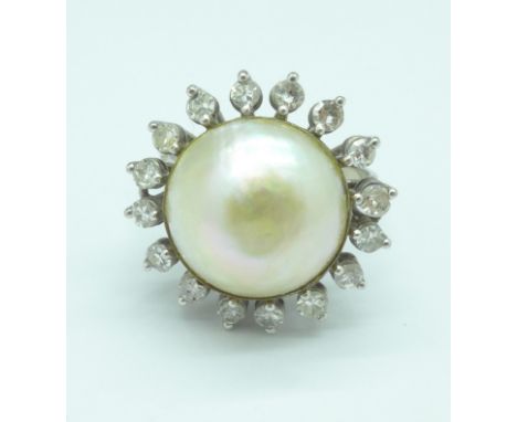 A white metal set ring with large blister pearl and sixteen diamonds, pearl 14mm, 6.9g, P