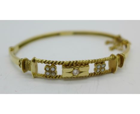 A 9ct gold, diamond and pearl bangle, 7.1g