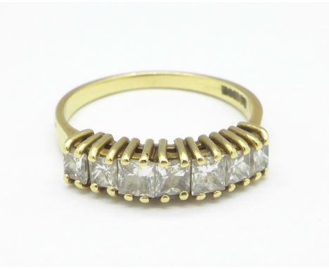 An 18ct gold ring set with seven square cut diamonds, 3.4g, O