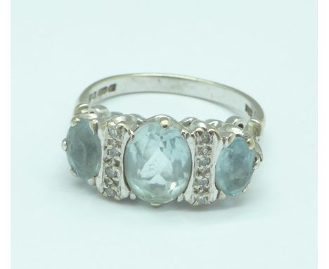 An 18ct white gold, blue stone and diamond ring, 4.8g, O