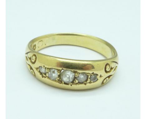 A yellow metal set five stone diamond ring, worn Birmingham hallmark, 4.1g, O