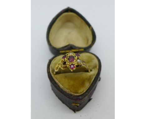 A Victorian yellow metal, ruby and seed pearl ring, one pearl missing, 1.6g, O