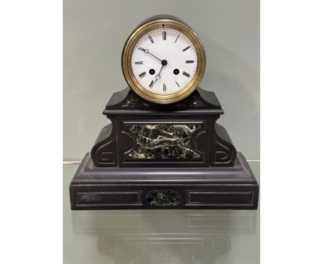 A 19th century French black slate mantle clock, with a circular enamel dial with Roman numerals and an eight day movement, th