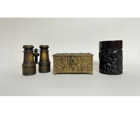 A cast brass reliquary/casket decorated with Biblical scenes in arched panels with a hinged lid revealing a red velvet lined 
