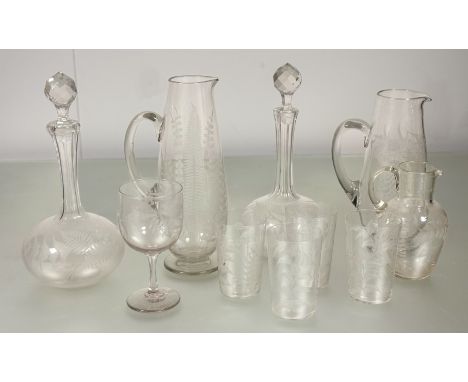 A collection of fern etched cut glass comprising, a pair of decanters with thumb cut neck with stoppers, a pitcher (h-24.5cm)