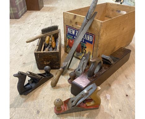 A crate containing a collection of vintage woodworking tools to include a wooden plane, two Acorn planes, chisels, files etc 