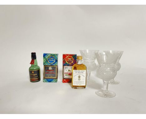 A set of three Edinburgh Crystal wine glasses with thistle-shaped bowls, etched thistle pattern to top, and raised on taperin