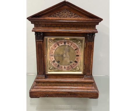 A Winterhalder &amp; Hofmeier oak cased mantle clock, with an architectual pediment and carved tympanum, with carved pilaster