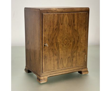 A 1920s miniature Whytock and Reid style burr walnut cabinet with panel door enclosing an internal shelf on splay bracket fee