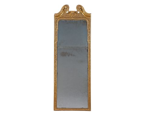 A Queen Anne Carved Giltwood Pier Glass England circa 1710, retaining the original plates, the lower plate bevelled, the gilt