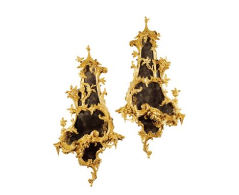 A Pair of Carved Rococo Giltwood Girandoles England circa 1760, of large size, retaining their original mirror plates, the bo