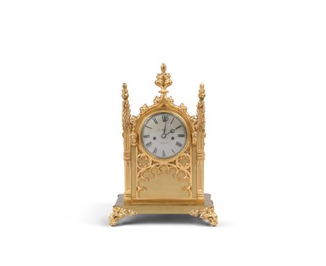 A Gothic Clock England circa 1860, signed Thos Moreland, Chester, the silvered face with Roman numerals is framed with a goth