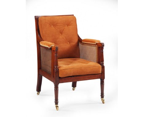 A Pair of Regency Library Armchairs England circa 1820, of large scale with caned seat, back and sides, the channelled hand r