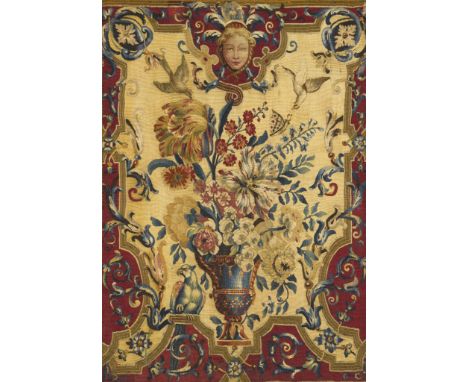 An Early 18th Century Tapestry Panel France circa 1720, depicting a flower-filled urn, with exotic birds, within a red ground