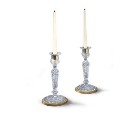 A Pair of Baccarat Glass and Ormolu Candlesticks France circa 1810, the form taking that of a gilt bronze candlestick with an