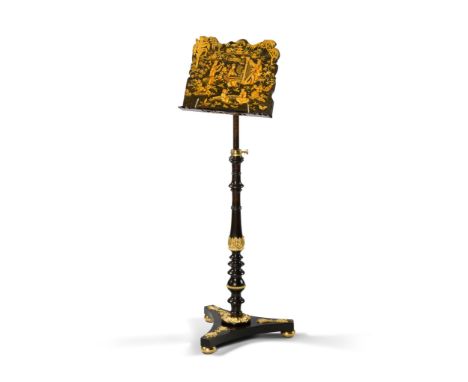 A Regency Music Stand England circa 1810, of elaborately shaped outline and decorated with fantastical gilt vignettes of a mu