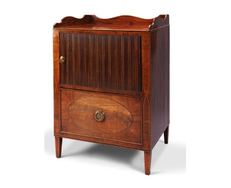 A Sheraton Mahogany Bedside Commode England circa 1780, the top having a shaped rail on three sides above a tambour front wit