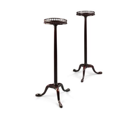 A Pair of George III Mahogany Torcheres England circa 1760, having circular galleried tops supported on fluted columns, stand