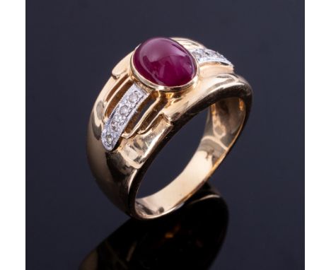 A wide band style ring set with a central cabochon cut ruby measuring 8.50mm x 6.50mm, approx. 2.00 carats in a rubover setti