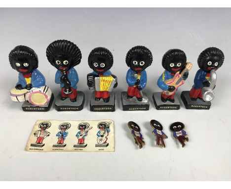Six vintage Robertson’s advertising figures together with three lapel badges