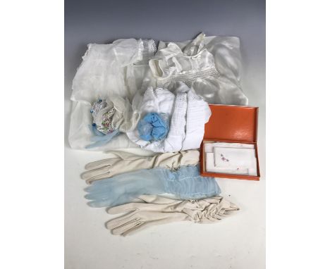 A small group of vintage costume and textiles including Christening dresses, boxed Lin Erin cotton handkerchiefs, and evening