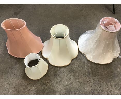 Three large lamp shades together with one other smaller shade