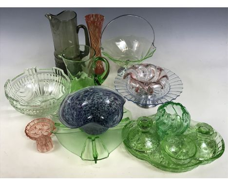 A quantity of vintage coloured glass wares including a uranium dressing table set, a cake stand and lemonade jugs etc