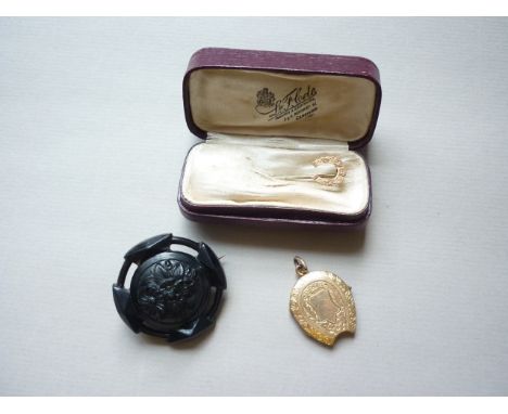 A Victorian yellow metal stick pin, the terminal modelled as a horseshoe, together with a similar rolled gold locket and a je