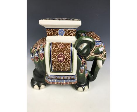 A green ceramic elephant stool