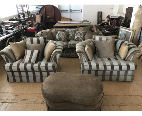 A quality four piece suite comprising a large three seater sofa and two large armchairs together with conforming pouffe