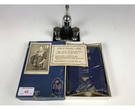 A novelty table cigarette lighter together with a cased George VI 1937 coronation bible