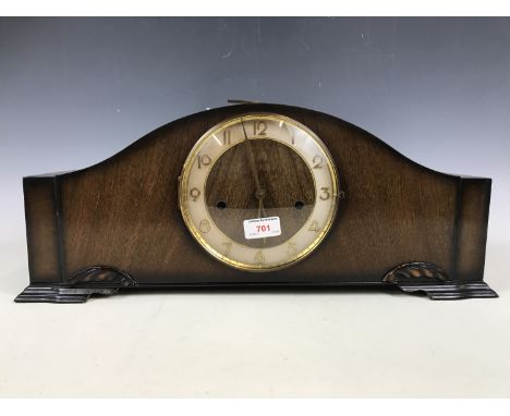 An early 1950s oak mantel clock of elongated shouldered form
