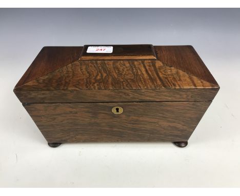 A late Georgian rosewood sarcophagus form tea caddy with later musical movement