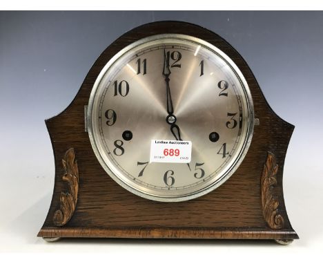 An oak cased mantel clock