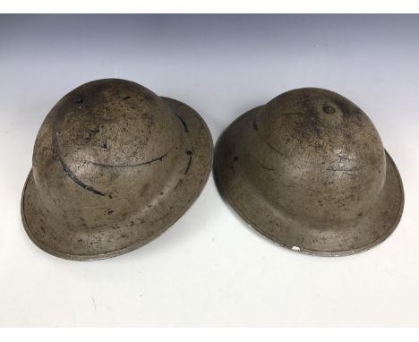 Two Second World War British army steel helmets