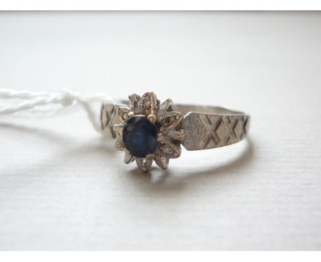 A vintage 18ct white gold sapphire and diamond dress ring, in a flower head arrangement with bark effect and faceted shank