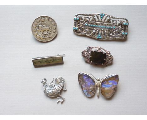 A quantity of vintage white metal brooches including a brooched silver Persian coin and an Art Deco and turquoise brooch