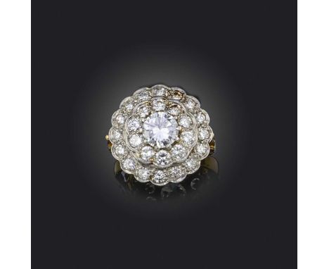 A diamond cluster ring, set with a central round brilliant-cut diamond weighing approximately 1.00cts, within concentric diam