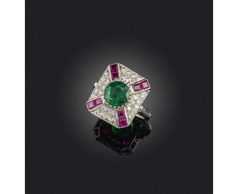 An emerald, ruby and diamond ring, designed as a plaque set with a circular-cut emerald, within a surround of brilliant-cut d