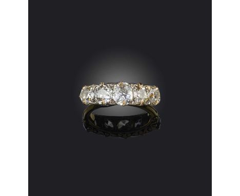 A late 19th century diamond five stone ring, set with graduated old cushion-shaped diamonds and diamond pointers in carved an