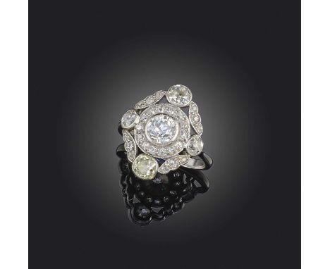 An attractive Belle Epoque diamond ring, circa 1915, designed as a foliate cluster, centring on a circular-cut diamond weighi