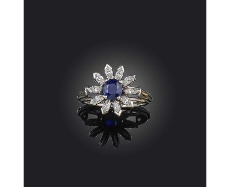 Birks, a sapphire and diamond ring, of cluster design, set with an oval sapphire within a border of marquise-shaped diamonds,