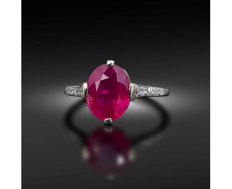 Cartier, a fine ruby and diamond ring, early 20th century, claw-set with an oval ruby weighing 3.30 carats, set with five cir