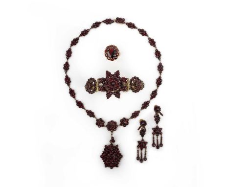 No reserve- A collection of garnet jewellery, comprising: a demi-parure of a necklace, bracelet and earrings, each set with r