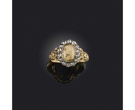 An agate and diamond ring, early 19th century, of cluster design, set with a cabochon agate within a border of rose-cut diamo