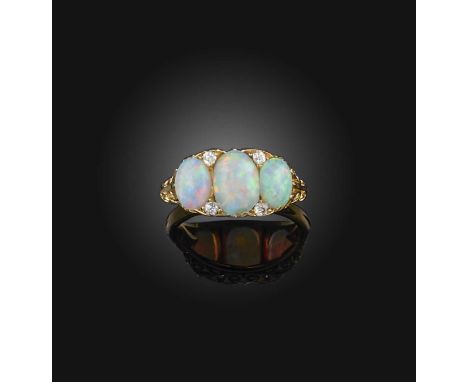 An opal and diamond ring, late 19th century, the oval opals mounted in a carved and pierced yellow gold setting accented with