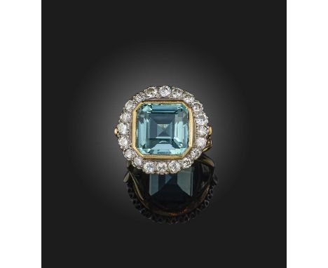 A blue tourmaline and diamond cluster ring, the square step-cut tourmaline set within a surround of diamonds in platinum and 