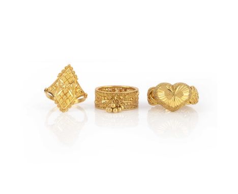 No reserve - a collection of three gold dress rings, India, each of ornate design with engraved and faceted detailing, in hig